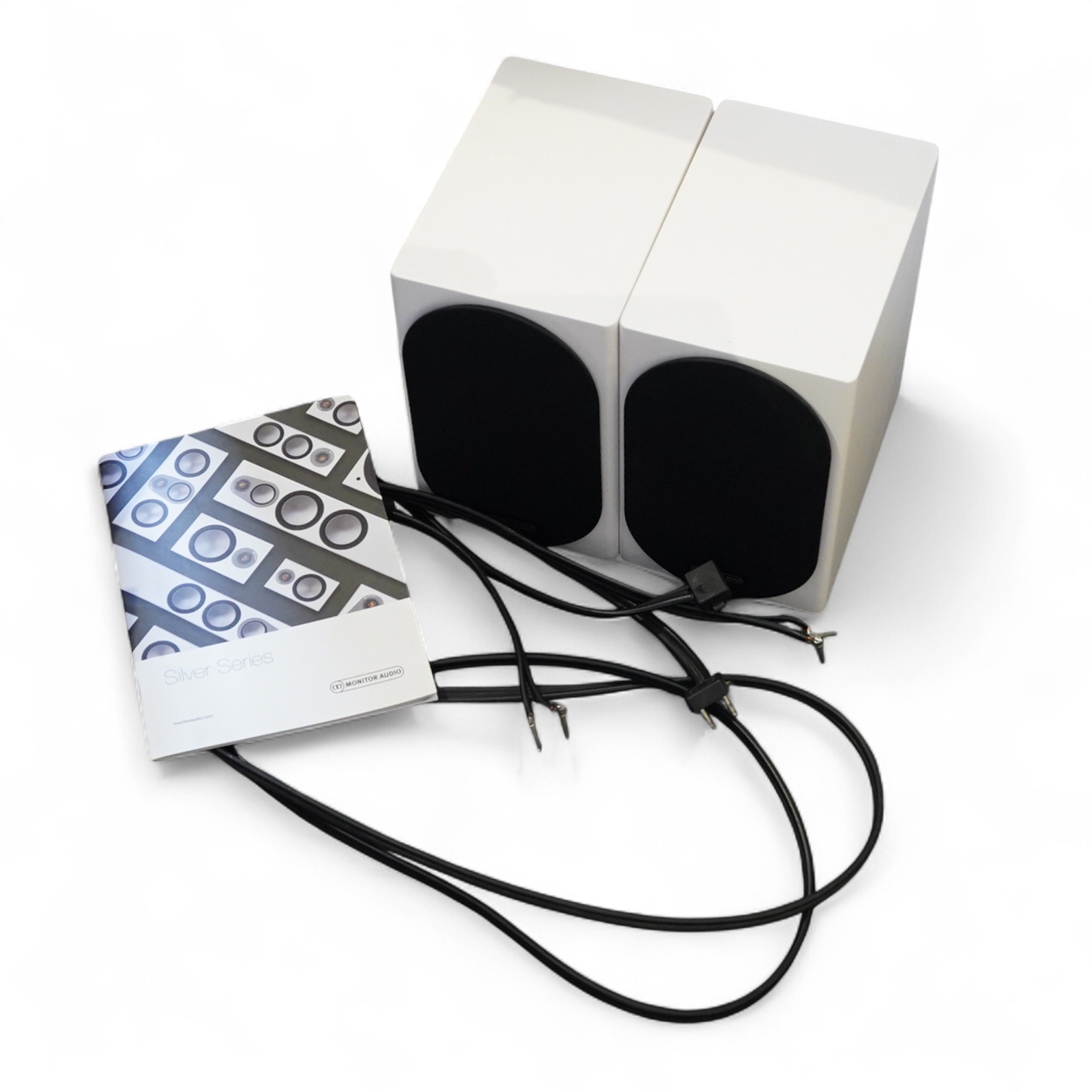A pair of Monitor Audio Silver Series ‘Silver 50’ stereo monitor speakers in satin white cases, height 27cm, width 16.5cm, depth 25cm, together with the silver series specification booklet and two related audio cables